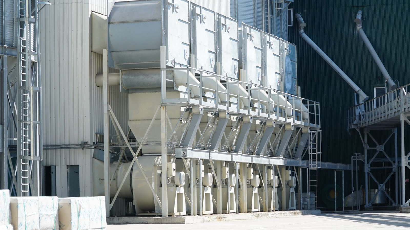 Rows of industrial bag filters, also known as fabric filters, used for dust collection in a plant.